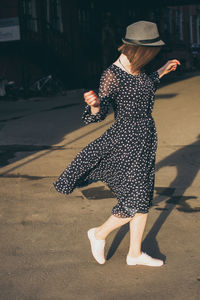 Rear view of woman walking on floor