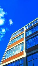 Low angle view of office building against blue sky