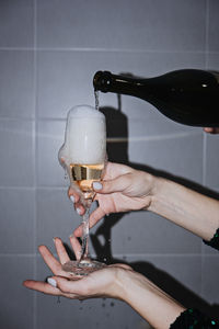 Nightlife, new year eve party champagne glass in female hands. close up cropped photo of female