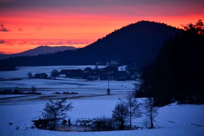 Scenic view of snowcapped mountains against sky during sunset