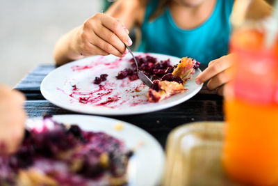 Close-up of woman eating food at table