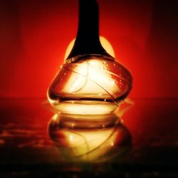 Close-up of illuminated lamp on table