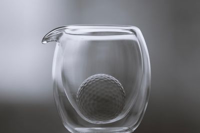 Close-up of golf ball in jar