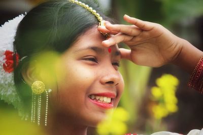 Close-up of young woman with flowers