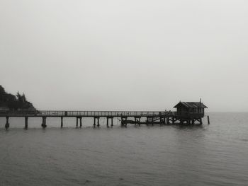 Pier in sea against clear sky