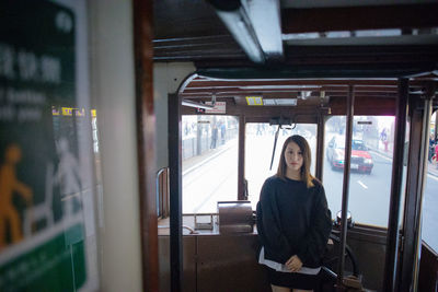 Portrait of woman standing in tramway