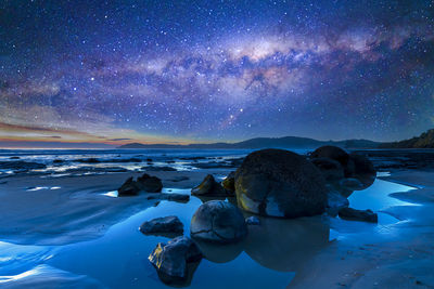 Scenic view of beach against sky at night