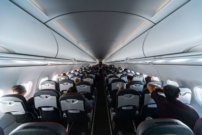 Rear view of people sitting in airplane