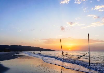 Hammock at beach during sunset