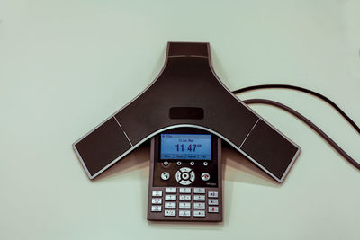 Close-up of telephone booth against white background