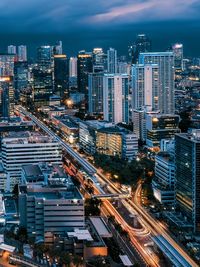 High angle view of illuminated city buildings at night