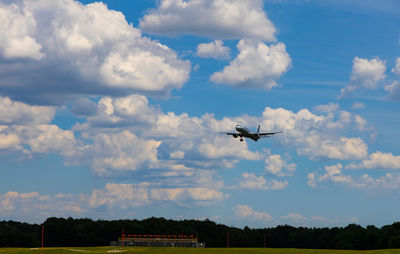 Low angle view of airplane flying against sky