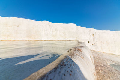 Scenic view of land against clear blue sky