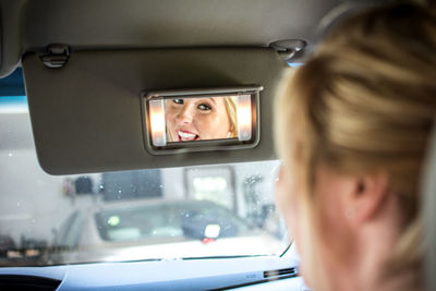 Close-up of young woman in car window