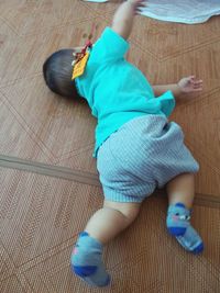 Low section of boy playing on hardwood floor