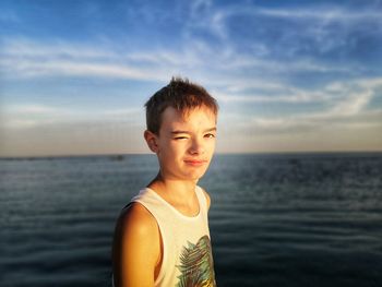 Portrait of boy against sea against sky