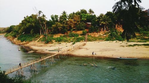 Scenic view of river by trees against sky