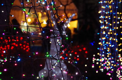 Defocused image of illuminated christmas tree at night