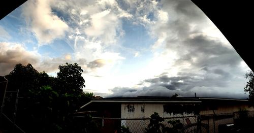 Low angle view of building against cloudy sky