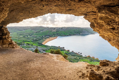 Scenic view of sea and mountains against sky