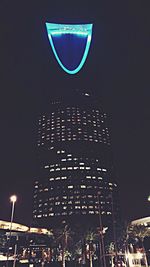 Low angle view of illuminated buildings against sky at night