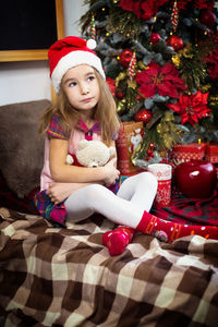 Portrait of teenage girl in christmas tree