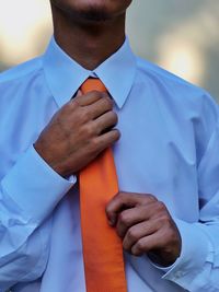 Midsection of man holding umbrella