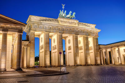 The famous illuminated brandenburg gate in berlin at blue hour with no people