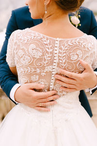 Midsection of couple at wedding ceremony