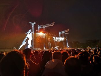 People enjoying music concert at night