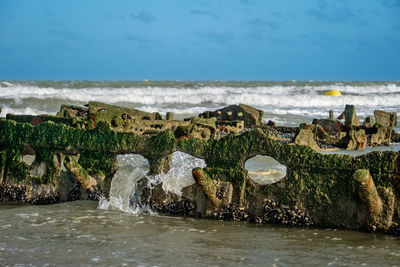 Water taking possession of a world war shipwreck at a beach in northern france