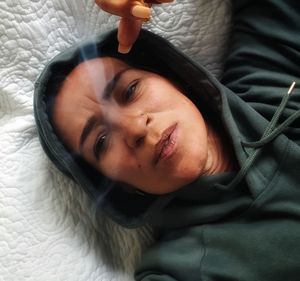 High angle portrait of baby girl lying on bed