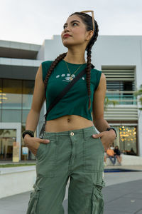 Portrait of young woman standing in city