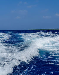 Scenic view of sea against blue sky