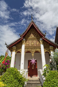 Low angle view of temple and building against sky