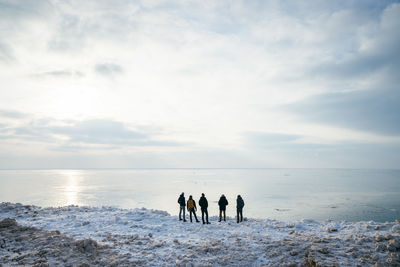 People on beach against sky