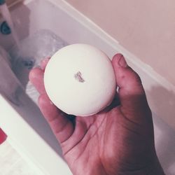 Cropped image of man holding soap in bathroom
