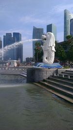 Statue in park with city in background