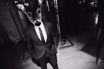 Man in suit wearing deer mask