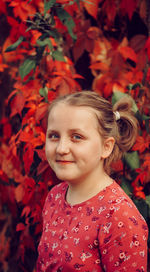 Portrait of smiling girl with autumn leaves