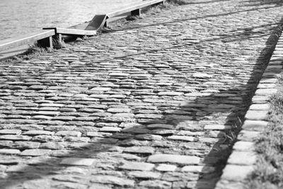 High angle view of footpath by cobblestone street