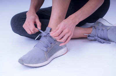 Low section of woman sitting on floor