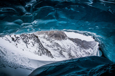 Close-up of frozen sea against mountain