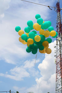 Low angle view of balloons against sky