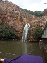 Scenic view of waterfall against sky