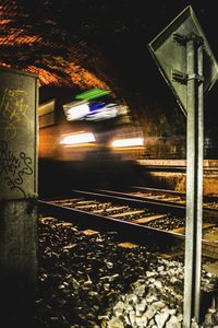 Illuminated railroad tracks at night