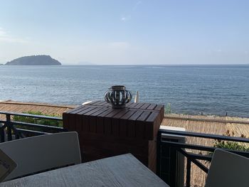 View of the sea in pizzuoli, italy on a beautiful sunny day from a deck patio.