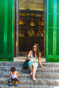 Portrait of smiling young woman sitting outdoors