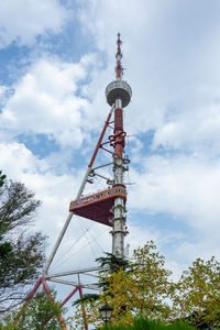 Low angle view of communications tower against sky