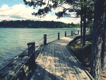 Pier over lake against sky